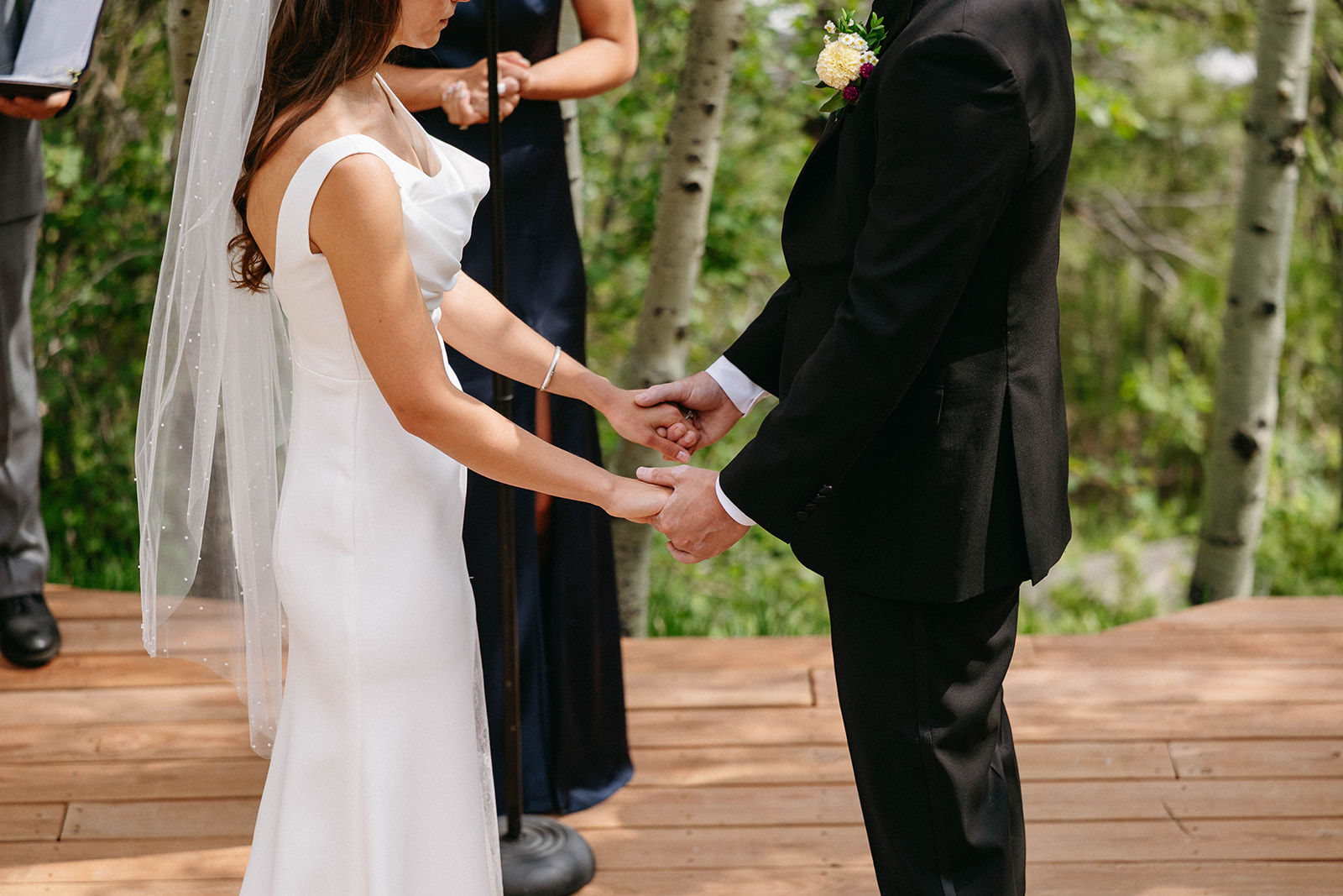 Jason and Amy kissing on the rocks framed by aspen trees